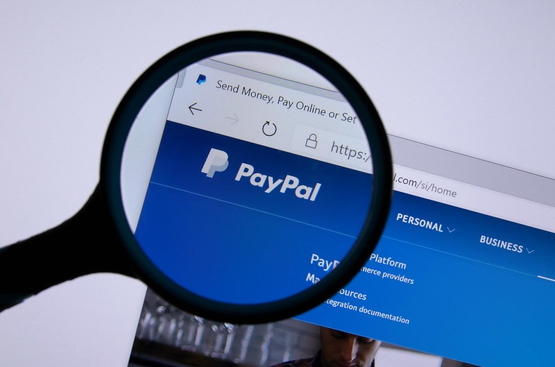Paypal Logo On Screen Under Magnifying Glass